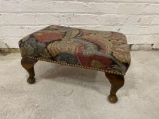 A 1940's Georgian style foot stool, the embroidered top with foliate design, studded edge on