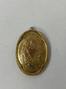 An Edwardian Birmingham locket marked 9 and .375, measures 4cm and weighs 5.23 grammes
