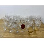 A quantity of glassware including whisky, wine, and sherry glasses, ash trays including two amber