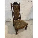 A Victorian rosewood slipper chair with intricately carved and pierced crest rail over embroidered