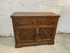 A south American hardwood side cabinet, the rectangular top over moulded frieze, two short drawers