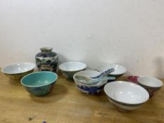 A collection of six rice bowls of various patterns and designs, also spoons, teacup, small dish