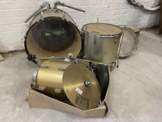 A set of drums, includes base, snare, miscellaneous other drums and cymbals, complete with stands