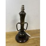 An Art Nouveau metal table lamp with later fixtures of naturalistic form with two handles to side on