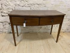 A Georgian mahogany bow fronted side table, the top with reeded edge over two drawers on straight