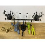 A group of novelty wall hooks including horns, rabbit, rhinoceros, deer and dogs tail also a coat