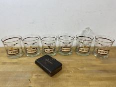 A set of six 1970's cocktail glasses inscribed Name Your Poison and each glass showing a different