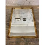 A contemporary wall mirror, the bevelled glass within a gilt composition frame, measures 136cm x
