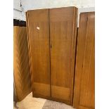 A Mid Century Avalon Yatton two-door wardrobe, interior with shelf and hanging space, on plinth