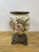 A china baluster shaped vase with metal insert top on metal base with scrolled feet, measures 26cm