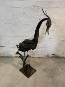 A sculpture of a heron standing on rectangular base, measures 122cm high