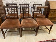 A set of six Regency mahogany side chairs with curved top rail on pierced banister back over