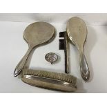 A Birmingham silver dressing table set including a hand mirror measuring 28cm,a hair brush, a