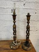 A pair of kashmiri spiral stem ebonised and floral painted table lamps, likely converted from
