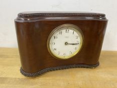 A late 19th early 20thc mahogany mantel clock of kidney shape with beaded top and moulded base on