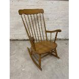 A modern beech rocking chair comb back on turned supports measures 96cm x 66cm 74cm