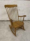 A modern beech rocking chair comb back on turned supports measures 96cm x 66cm 74cm