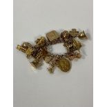 A 9ct gold charm bracelet with a quantity of charms, most marked 9ct, measures 8cm, combined