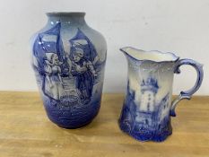 A Dutch blue and white vase with raised figures of boy and girl before fishing boats, stamped