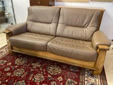 A modern sofa with oak frame and chocolate brown leather, back and seat cushions, measures 93cm x