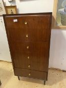A Mid Century teak tallboy chest of drawers, the rectangular top over six drawers on turned tapering