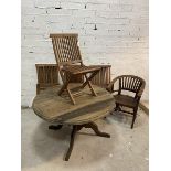 A weathered hardwood garden dining set including circular pedestal dining table (one leg a/f),