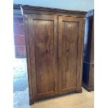 An Edwardian mahogany wardrobe, the twin handled doors enclosing interior fitted for hanging and