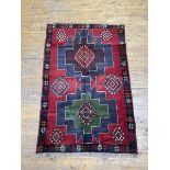 A New Baluchi rug with two geometric medallions within a multiple stylised flowerhead border,