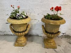 A pair of 19thc two-part fire clay garden urns with honey glaze with leaf moulded design and handles