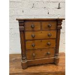 A 19thc mahogany apprentice chest of drawers, the inverted break front top over two short drawers