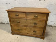 An Edwardian ash chest of drawers, the rectangular moulded top over two short drawers and two