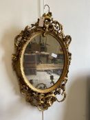 A 19thc giltwood and composition girandolle mirror, the oval plate within a conforming frame