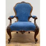 A Victorian walnut framed open armchair, the crest rail carved with 'C' scrolls and acanthus leaf