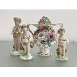 A group of three Derby porcelain putti, 18th century, the tallest carrying a basket of birds, the