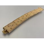 Cartier: an 18ct yellow gold textured mesh-link bracelet manufactured by Unoaerre, Italy, the