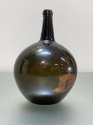 A late 18th/early 19th century green glass bottle of globe and shaft form, with gilt label "4".