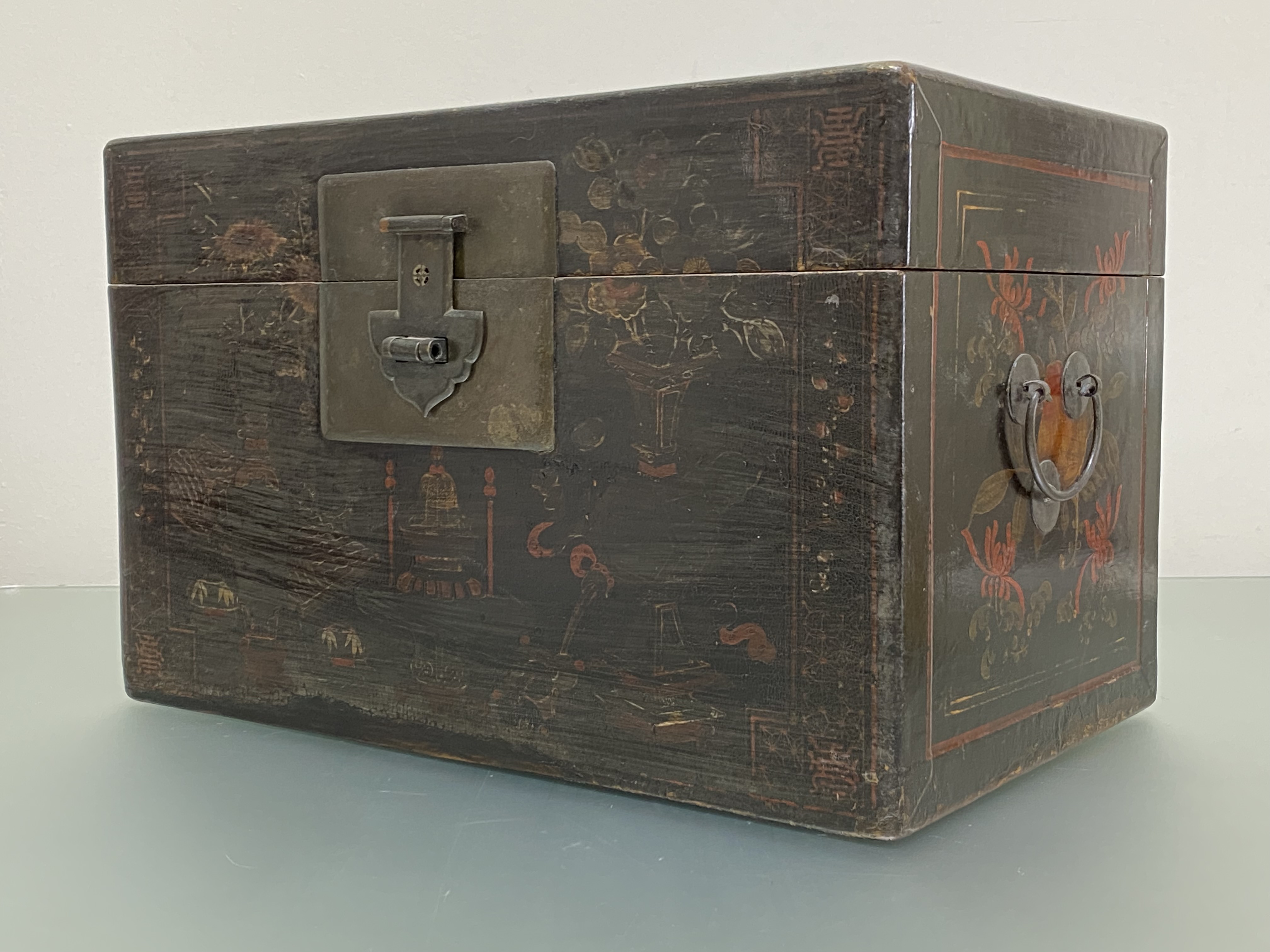 A Chinese black lacquer box, 19th century, decorated with flowers, fruit and precious objects,