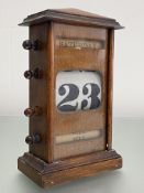 An oak perpetual desk calendar, c. 1930. Height 24cm