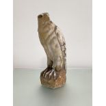 An Italian carved alabaster model of a hawk or falcon, early 20th century, modelled perched on a