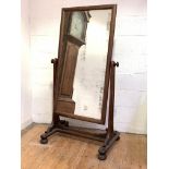 A William IV mahogany cheval mirror, the foxed rectangular plate within a conforming frame