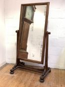 A William IV mahogany cheval mirror, the foxed rectangular plate within a conforming frame