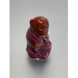 A Burmantofts Faience model of a seated monkey, in an oxblood glaze, incised no. 1996 and factory