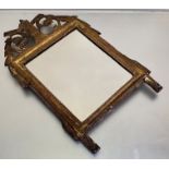 An early 19th century small giltwood wall mirror, probably French, the rectangular plate within a