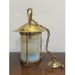 A brass and vaseline glass hanging lantern in the Art Noveau style, the baluster-cast frame