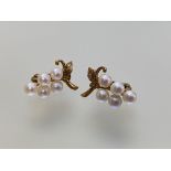 A pair of 9ct gold cultured pearl earrings, each modelled with five uniform pearls as grapes on a