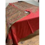 A 19th century woollen Paisley shawl, the central crimson reserve within broad borders worked in
