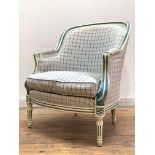 A French bergère in the Louis XV taste, the cream and blue painted fluted show frame enclosing back,