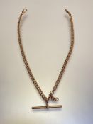 An unmarked yellow metal Albert chain, of curblinks, with t-bar and lobster clasp. Length 38cm, 22
