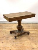 A William IV rosewood tea table, the fold over swivel top over a faceted octagonal baluster