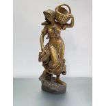 A large late 19th century gilt-plaster figure of a girl, a basket on her left shoulder, unsigned.